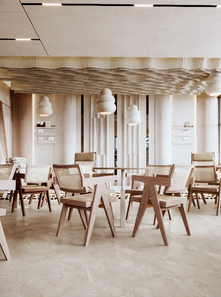 Cafe seating under the sculpted ceiling raft, with fluted screen walls, cane chairs and stacked-orb pendants