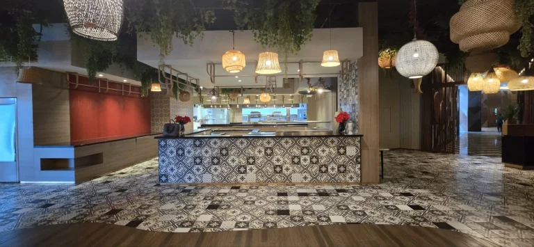 The existing bar in patterned tile, open kitchen behind