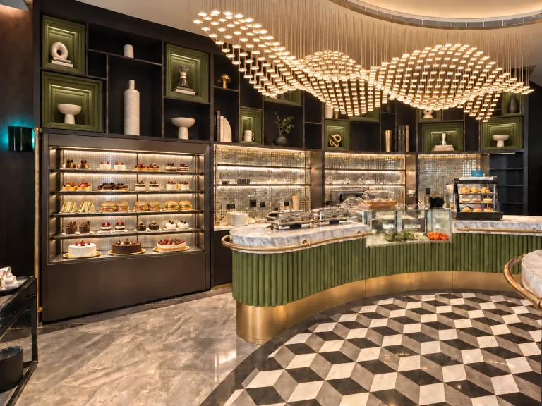Cafe bar counter and patisserie display in green and brass