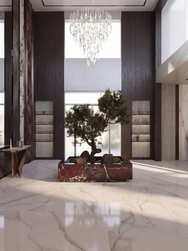 Double-height entrance lobby with an olive tree set in a red marble planter under a crystal chandelier